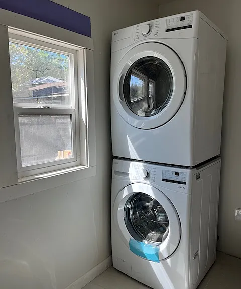 Separate room off the kitchen leading to the spacious outdoor space holds the full size washer and dryer and space for a desk/table. Two windows for natural lighting and view into the yard.