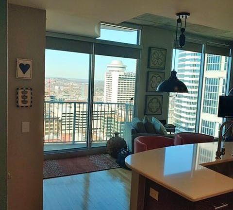 Living area with view of balcony. Entire unit has wrap around windowns