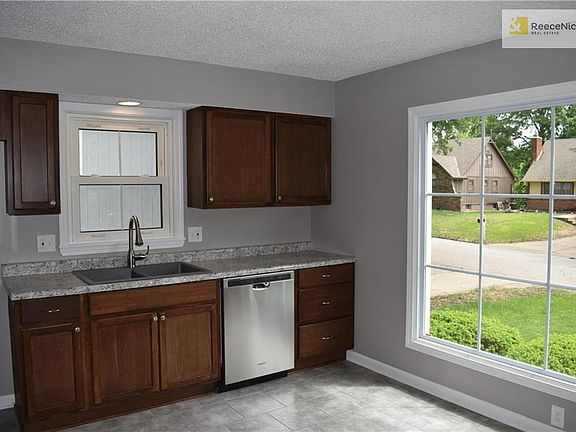 Completely remolded kitchen with new countertops, new stainless steel appliances, new bay window, new floor tile.