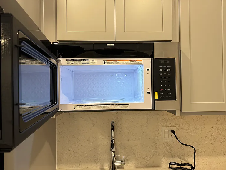 View of vented microwave with door opened.