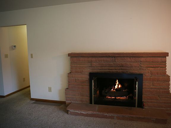Gas fireplace and hallway towards bedrooms.