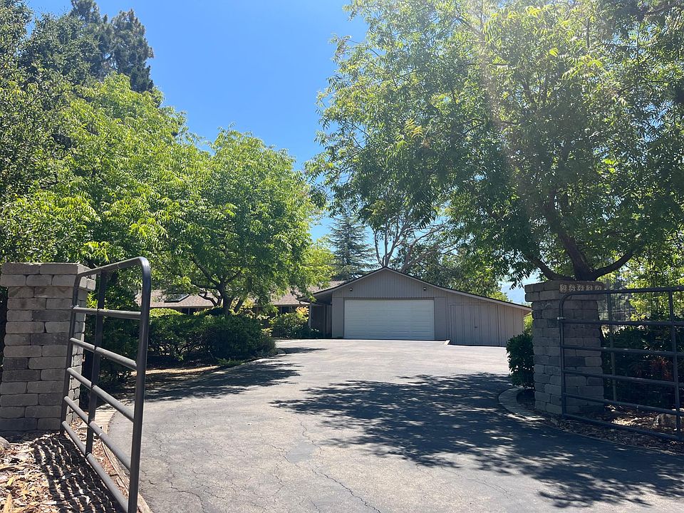 Beautiful single-story 2,589 square foot 3-bedroom 2.5-bath mid-century house situated in a large 1.4-acre lot in Los Altos Hills