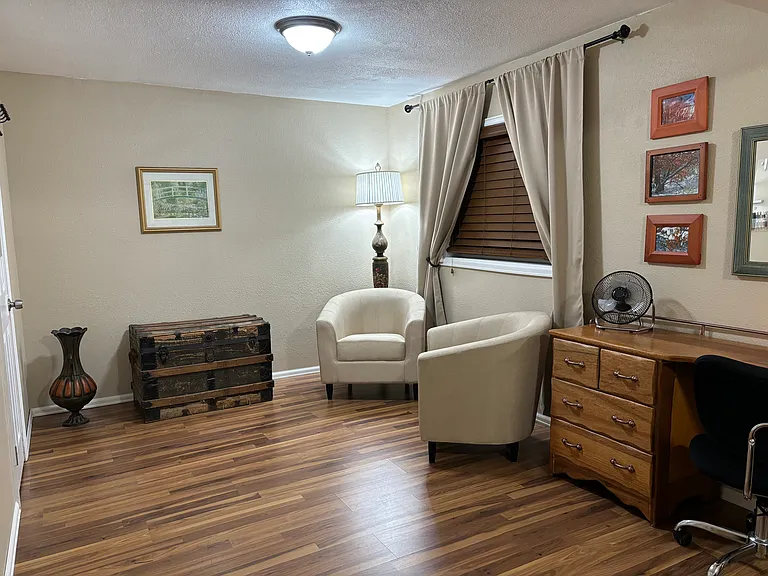 Bedroom: sitting area, 2 windows with window film & custom blinds for privacy