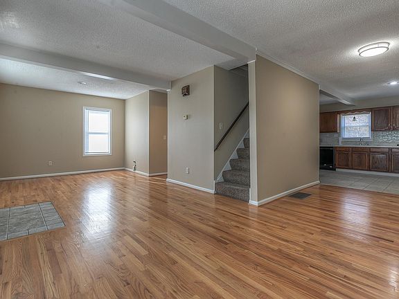 Living room wraps around to dining room and kitchen.