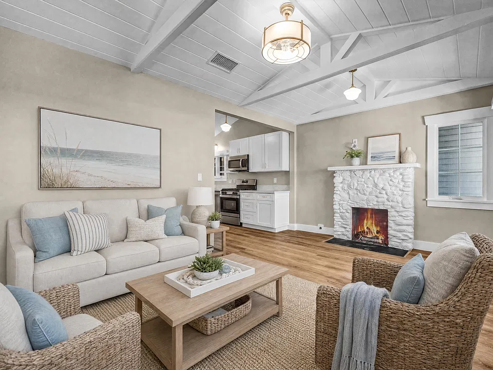 AI-Staged Living Room | Cozy fireplace, peek-a-boo ocean views, and inviting coastal charm.