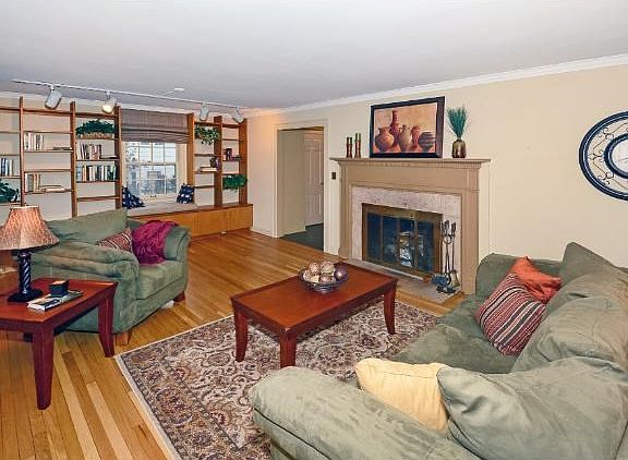 The large front room has a wood burning fireplace, original hardwood floors and built-in book cases. The large windows allow for loads of natural light.
