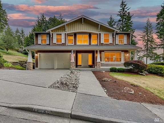 Authentic Craftsman design with large covered front porch with classic tapered columns.  Even though you only see two garage doors, there are three parking stalls with one being tandem - offering lots of storage options!