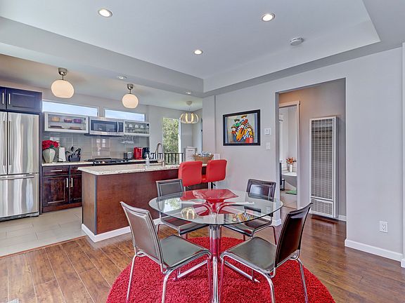 Dining room, kitchen with hallway to upstairs bedroom and bathroom.