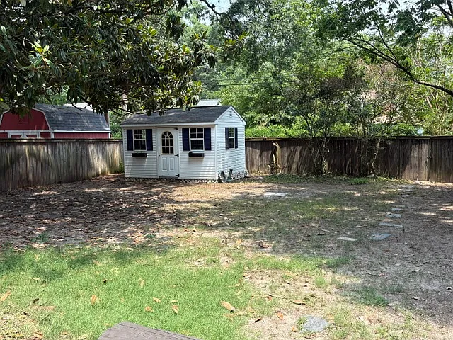 Large fenced back yard with storage shed