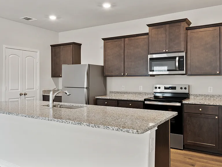 The kitchen has gorgeous wood cabinetry.