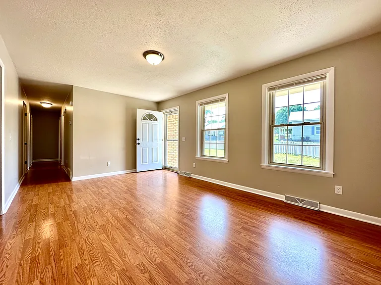 The wood floor gives it a warm and inviting feel, while the large windows make the room feel bright and airy. Can you already picture yourself relaxing in this beautiful space. #dreamhome #rentalgoals