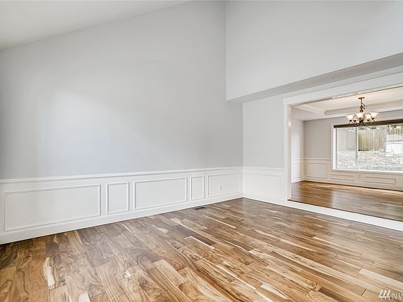 Be greeted by gleaming acacia wood floors, new paint and soaring ceilings!