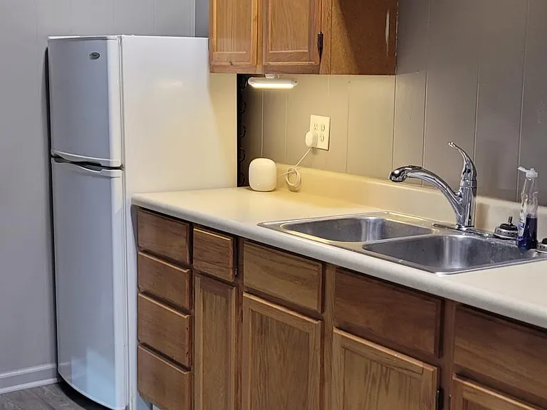 Kitchen from bedroom doorway. Electric stove, Refrigerator/freezer, Microwave, Air Fryer multifunctions. no dishwasher, but garbage disposal.