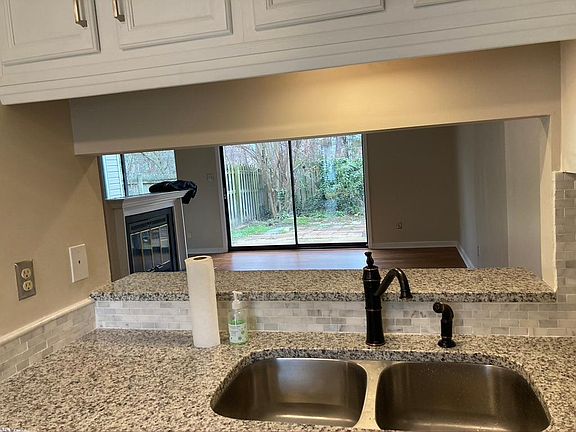 Passthrough from kitchen to dining/family room with place for barstools.