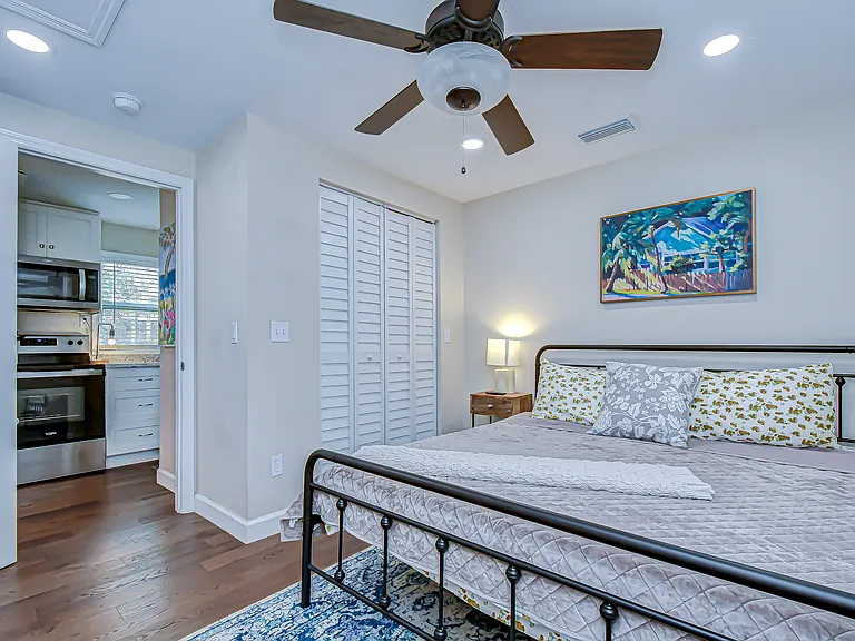 the guest bedroom also features a king size bed, end stand and large closet