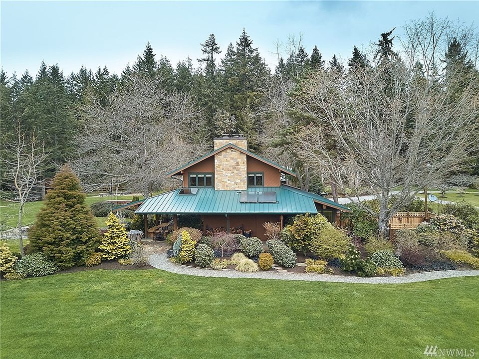 Beautifully sited with all day sun, the handsome main house was designed by  renowned Island architect, Hal Molstad and features 3 bedrooms, 2 gorgeous baths, private office, great room, family room and gourmet kitchen.