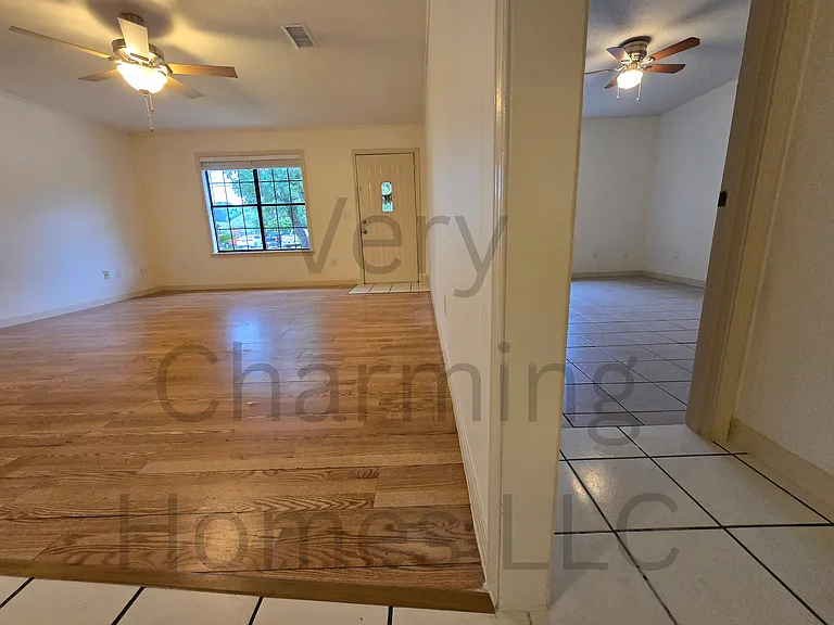 This apartment is very clean and freshly painted! From the middle of the apartment, looking back toward the front, you have a beautiful front window and front yard view. You can also see that there is a front bedroom next to the living room.