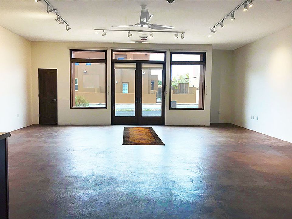 775 square foot main live/work, residential or commercial open loft space facing front doors. Notice the ten-foot ceilings, large modern fan and dimmable track lighting.