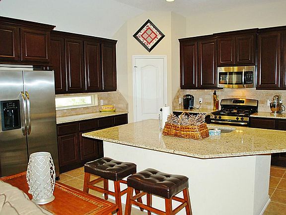 Amazing kitchen with 42-in cherry finish cabinets, stainless appliances featuring gas range and oven