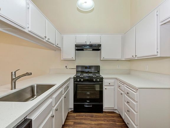 Bright and airy kitchen with updated appliances, Quartz countertops, and undermount, stainless steel sink.