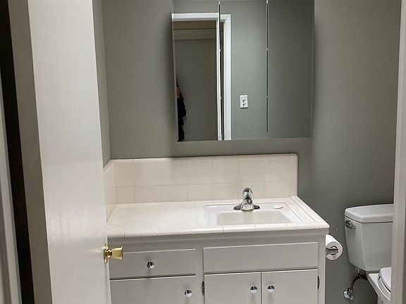 Bath with tub and shower. Skylight over sink.