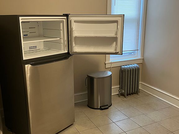 Large 10x14 eat in kitchen with ceramic tile and all brand new stainless steel appliances and a lot of cabinet space, along with a large wall pantry