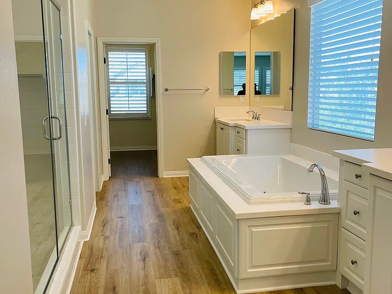Master Bathroom with Jacuzzi tub, large separate shower and toilet room (taken from master bedroom).