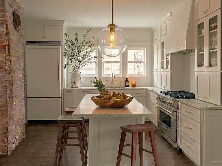 Sublime chef's kitchen filled with natural light, LUX finishes and nine foot ceilings. Gorgeous white marble countertops, backsplash and an oversized plaster range hood compliment the warmth of walnut floors while exposed brick adds historic charm.