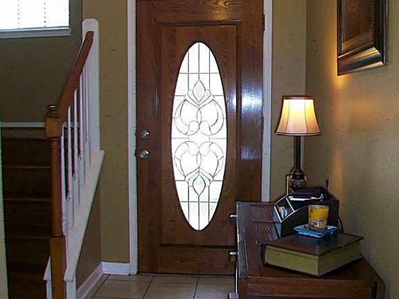2.STORY TILE FOYER, WITH HARDWOOD STAIRS TO THE UPPER LEVEL