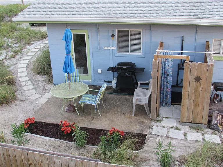 Back patio with fully-enclosed hot/cold water shower.