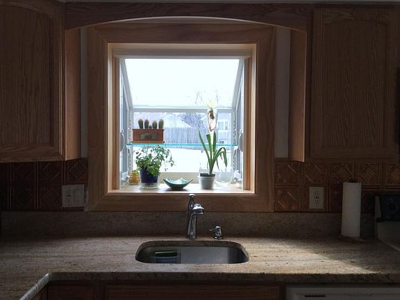 Beautiful Green-House Window to view out of as you work at the kitchen sink.