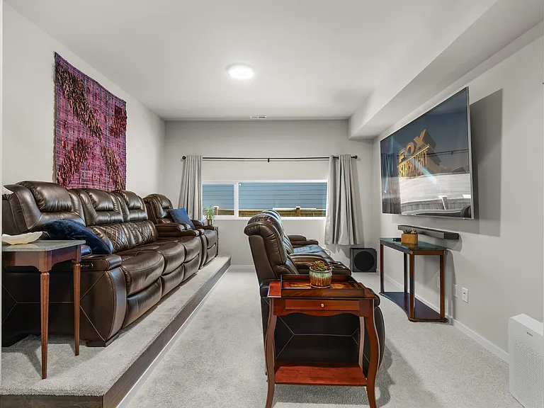 Large theater room with black out curtains and fully reclining chairs. Seats 8