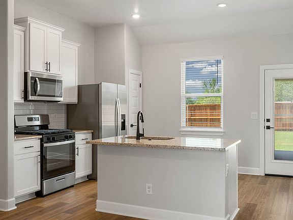 The upgraded kitchen has a convenient kitchen island for added convenience.