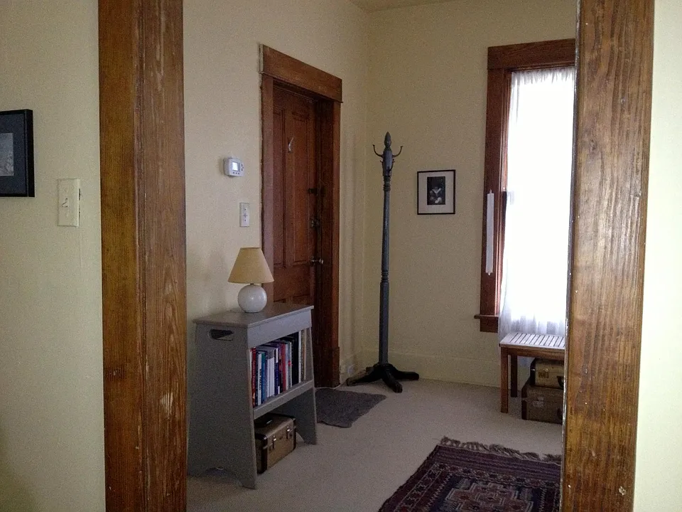 Front/southeast room, entry door. All flooring to be replaced prior to 11-1-22
