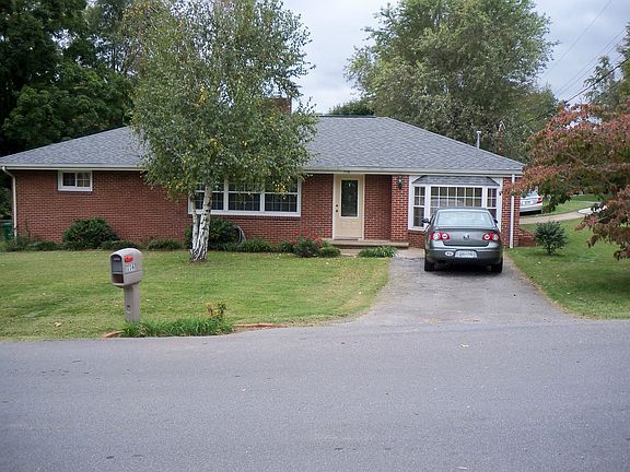 Corner lot with two driveways and carport
