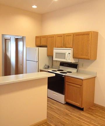 The kitchen breakfast bar and far wall. Also shows the pantry in the laundry/utility room.