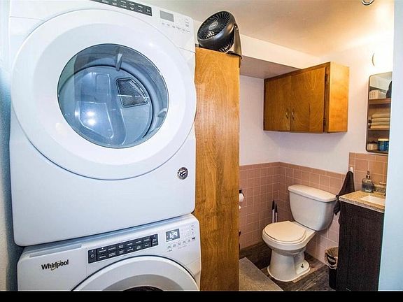 Full bathroom with washer and dryer