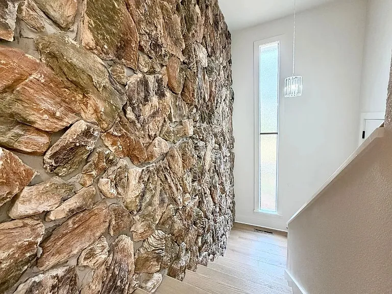 Looking down at stair landing from living area.