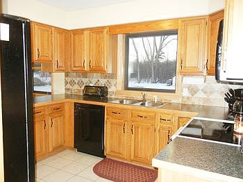 Kitchen features newer countertops, backsplashes and hardware