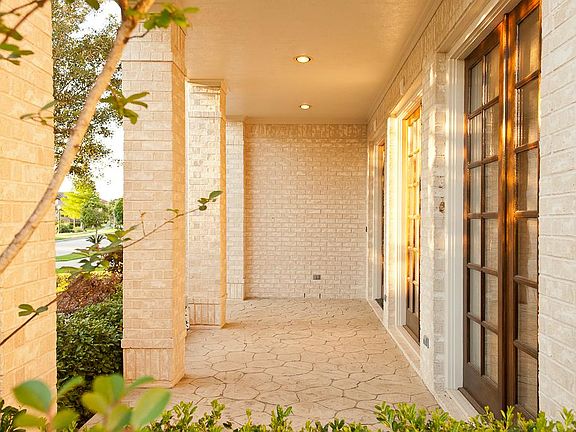 Covered front porch. Stamp concrete looks like stone.