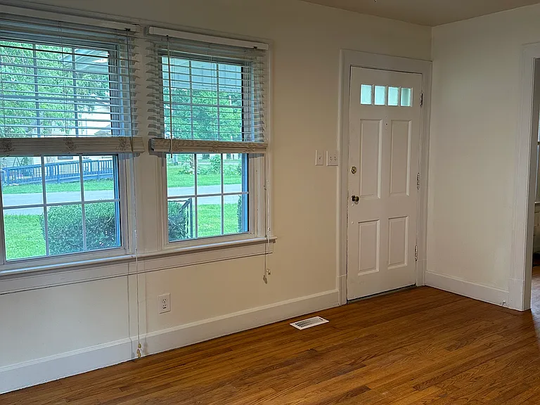 Living room with 2 front windows and 1 on side of house. Includes the front door.