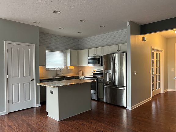 Kitchen, large pantry (door), granite countertops and SS appliance's. Large island with additional cabinets underneath for large storage