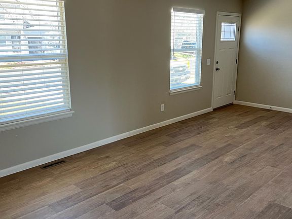 Living room with new laminate flooring, new window coverings