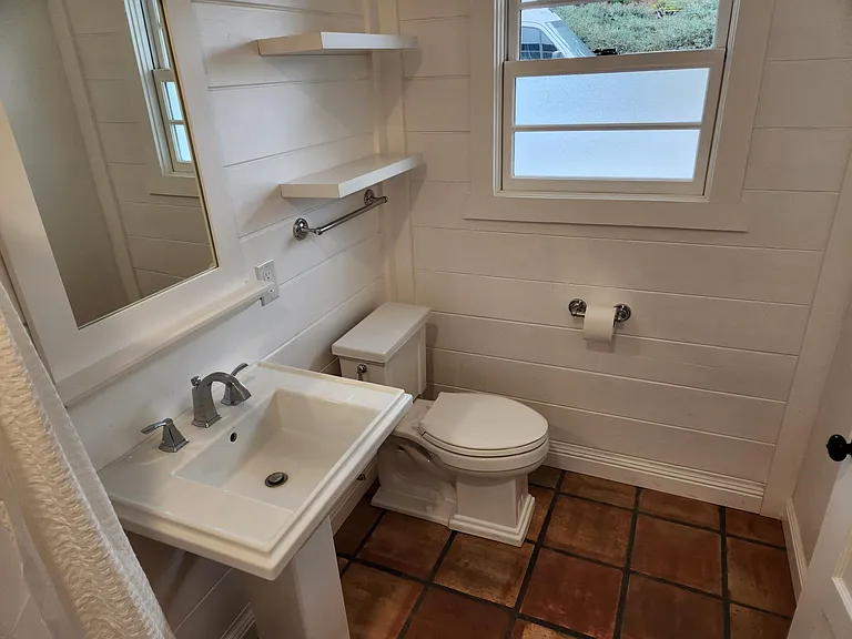 Bathroom has lots of character and style.