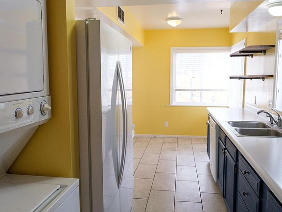 Bright kitchen has lots of windows, room for a breakfast nook, washer and dryer, refrigerator and new gas range. There is also a pantry and a door that leads to the backyard.