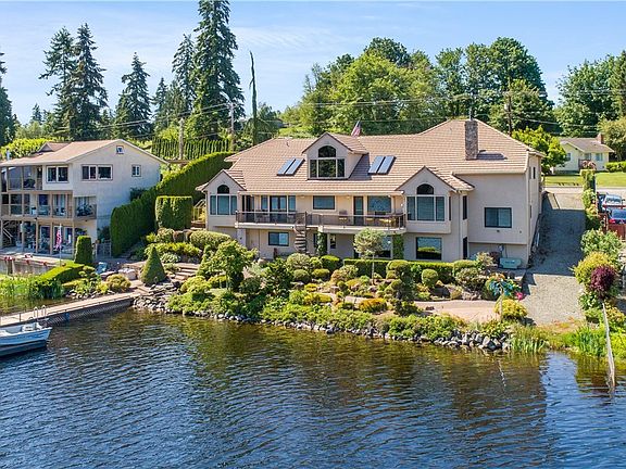 From the lake, you'll appreciate the stunning landscape and back view of home. 