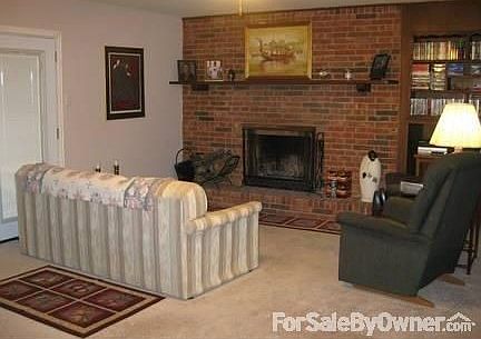 Comfortable Family Space : A wood-burning fireplace with built-ins for books and DVDs