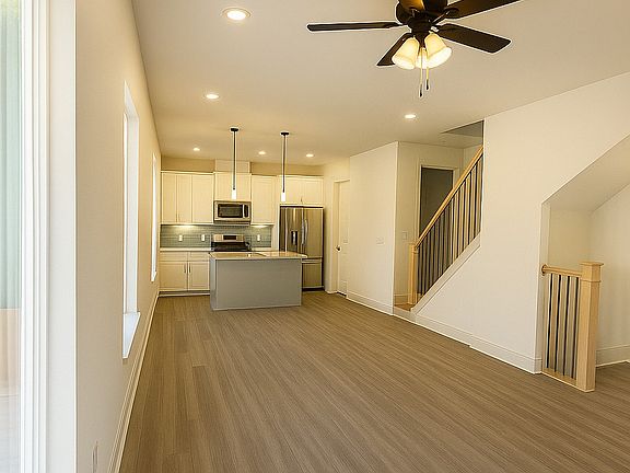 This beautifully designed home features a bright, open-concept layout that seamlessly connects the kitchen, dining, and living areas. Large windows fill the space with natural light, highlighting the sleek finishes, modern fixtures, and neutral tones.