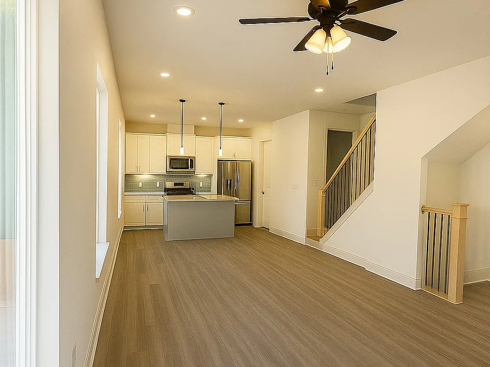 This beautifully designed home features a bright, open-concept layout that seamlessly connects the kitchen, dining, and living areas. Large windows fill the space with natural light, highlighting the sleek finishes, modern fixtures, and neutral tones.