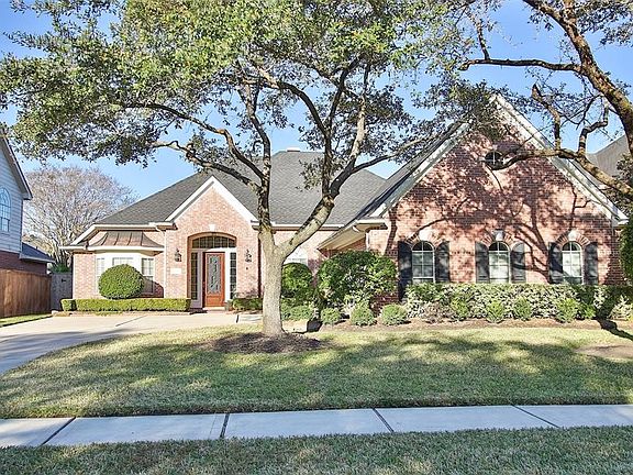 The convenient attached garage has gleaming polished epoxy floors and a built in storage cabinet.